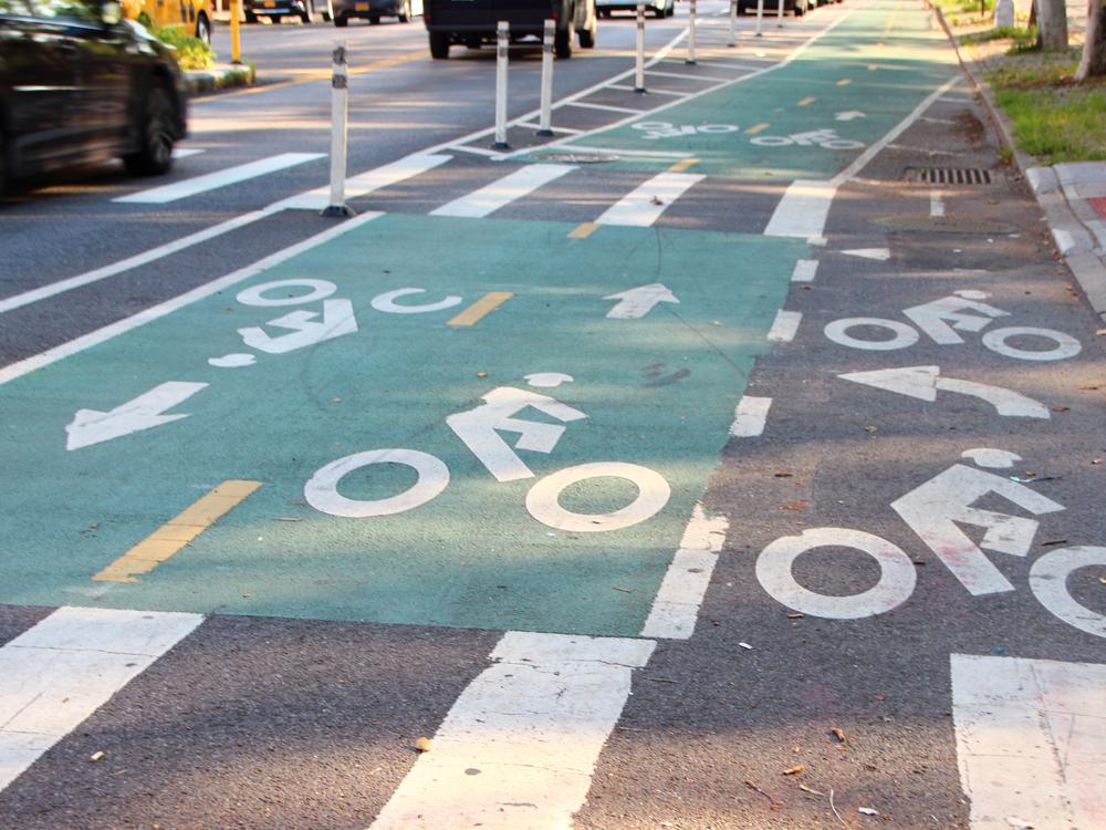 A cyclist riding in a Chicago bike lane while learning about legal protections.